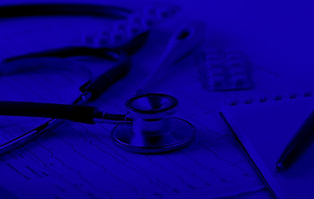 Stethoscope sitting on a pile of medical records waiting to be reviewed