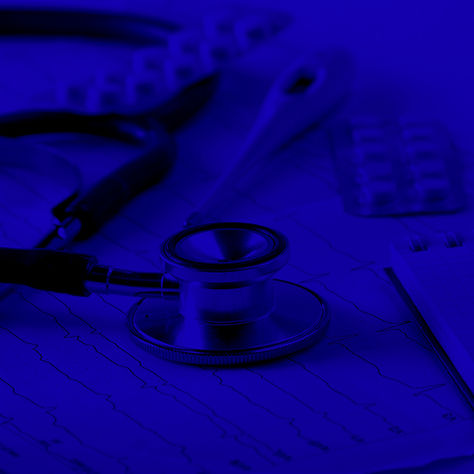 Stethoscope sitting on a pile of medical records waiting to be reviewed